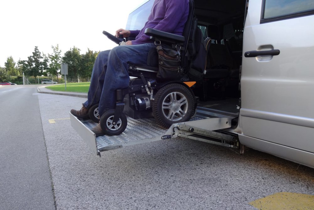 Person in a wheelchair coming out of a accessible van