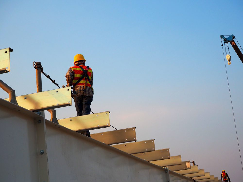 Construction man working on a building roof